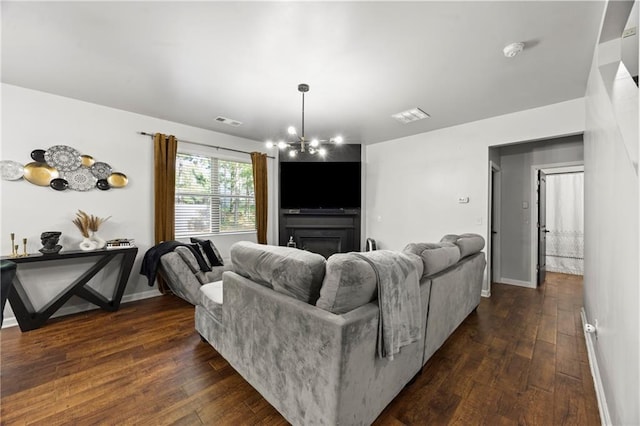 468 Lake Ridge Ln, Fairburn, GA 30213 - living area featuring dark wood-type flooring, a chandelier, baseboards, and a fireplace