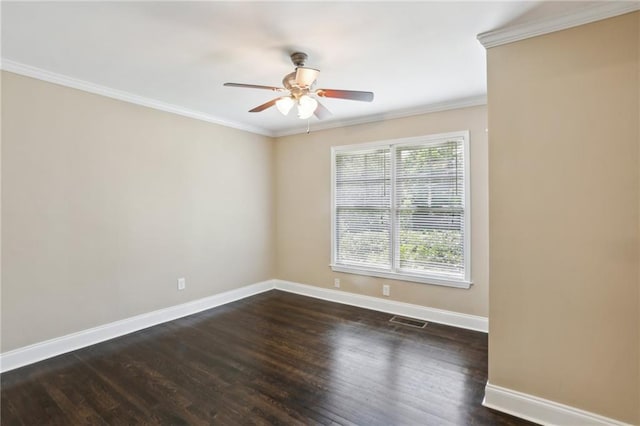 empty room featuring dark wood-style flooring, crown molding, baseboards, and visible vents