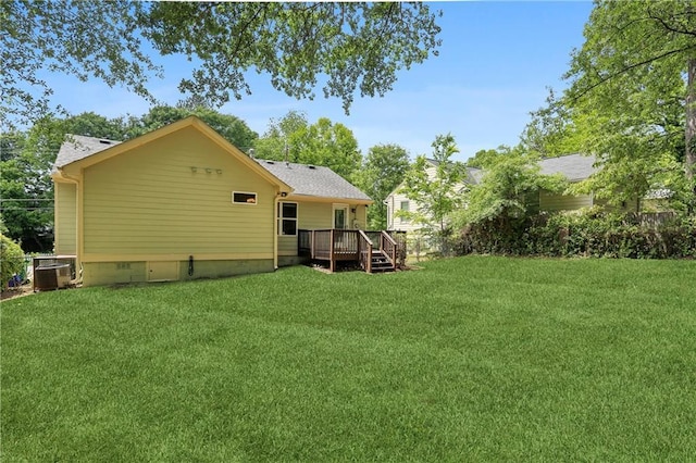 rear view of property featuring crawl space, a deck, central AC unit, and a lawn