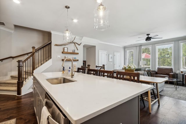 243 Retreat Ln, Canton, GA 30114 - kitchen with a sink, stainless steel dishwasher, ornamental molding, light countertops, and an island with sink