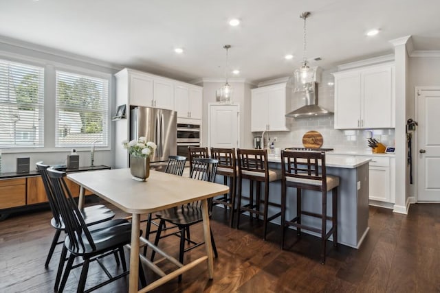 243 Retreat Ln, Canton, GA 30114 - kitchen featuring wall chimney exhaust hood, ornamental molding, appliances with stainless steel finishes, tasteful backsplash, and light countertops