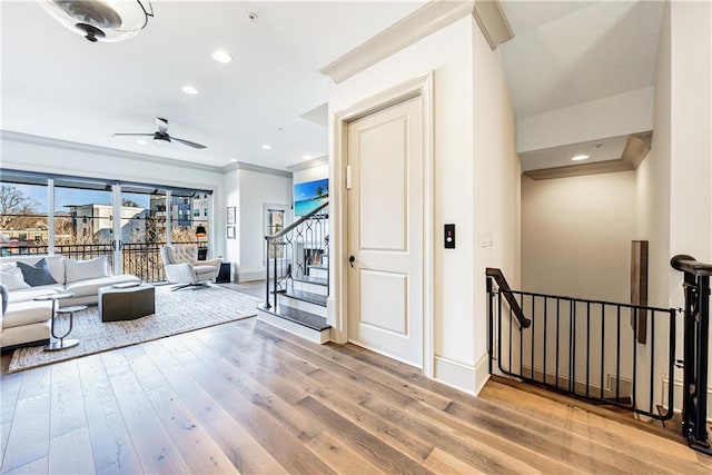 661 Auburn Ave NE Unit 10, Atlanta, GA 30312 - living area featuring a ceiling fan, wood finished floors, crown molding, recessed lighting, and stairs