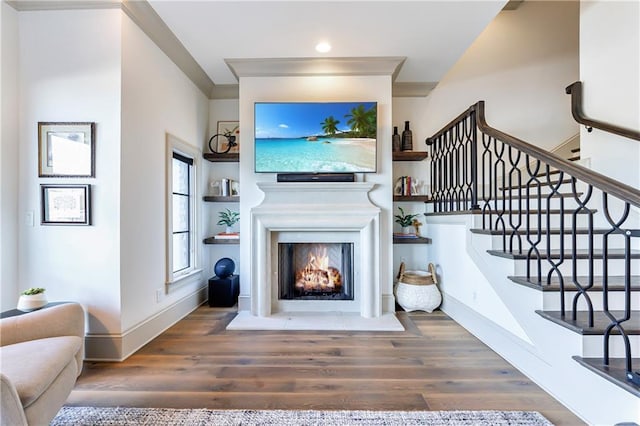 661 Auburn Ave NE Unit 10, Atlanta, GA 30312 - living area with wood finished floors, a warm lit fireplace, stairs, and recessed lighting