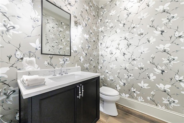 661 Auburn Ave NE Unit 10, Atlanta, GA 30312 - half bathroom featuring wallpapered walls, wood finished floors, and vanity