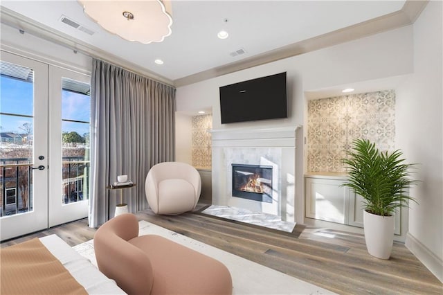 661 Auburn Ave NE Unit 10, Atlanta, GA 30312 - living room with wood finished floors, a tile fireplace, recessed lighting, and french doors