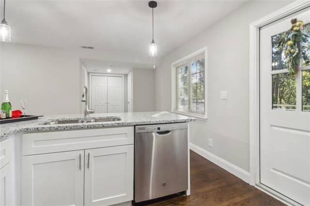 kitchen with dishwasher, white cabinets, sink, hanging light fixtures, and dark hardwood / wood-style floors