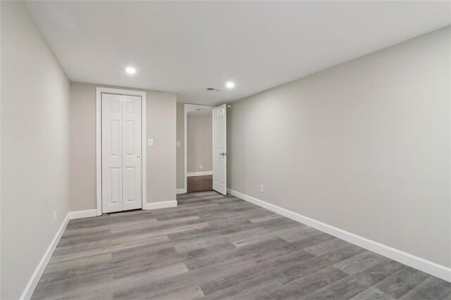 unfurnished bedroom with light hardwood / wood-style floors and a closet