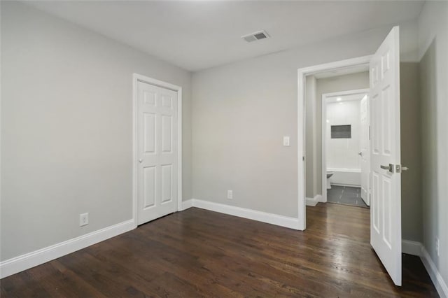 unfurnished bedroom featuring dark hardwood / wood-style floors