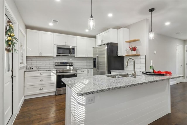 kitchen featuring white cabinets, sink, hanging light fixtures, kitchen peninsula, and stainless steel appliances