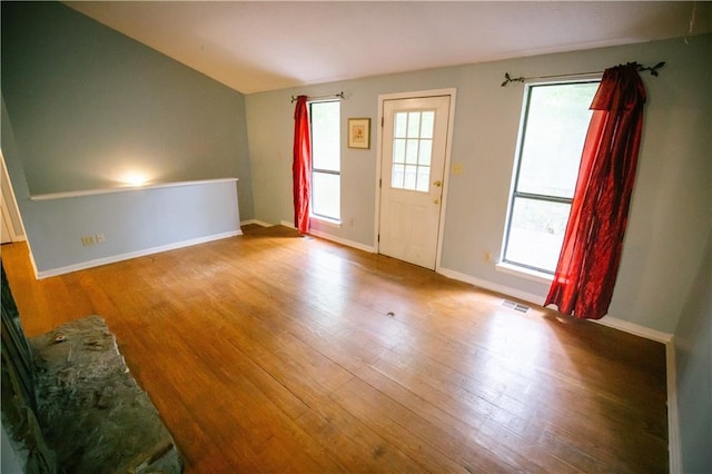 4190 Heather Way, Cumming, GA 30041 - unfurnished living room with wood finished floors, baseboards, and lofted ceiling