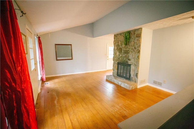 4190 Heather Way, Cumming, GA 30041 - unfurnished living room with wood finished floors, lofted ceiling, a fireplace, and baseboards