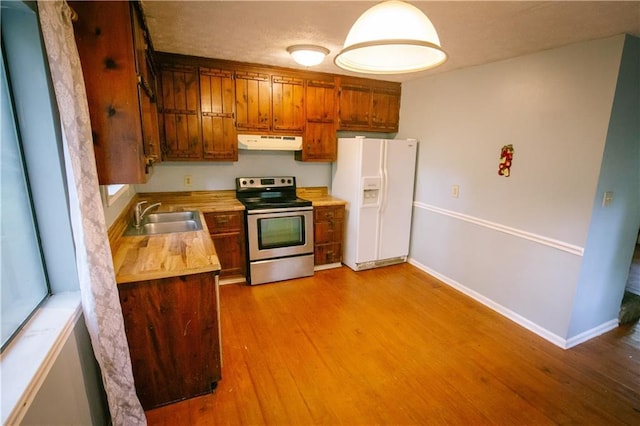 4190 Heather Way, Cumming, GA 30041 - kitchen with stainless steel electric range oven, white refrigerator with ice dispenser, a sink, under cabinet range hood, and wood finished floors
