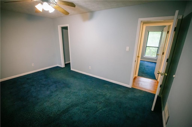 4190 Heather Way, Cumming, GA 30041 - empty room featuring dark colored carpet, ceiling fan, and baseboards
