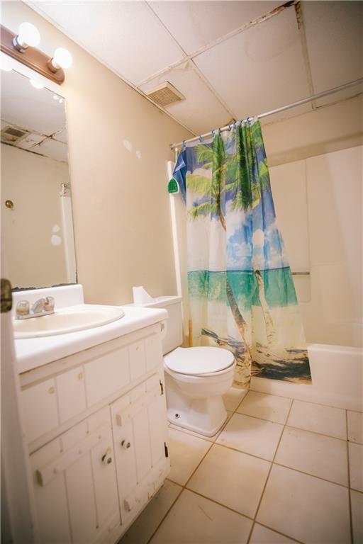 4190 Heather Way, Cumming, GA 30041 - bathroom featuring tile patterned floors, vanity, toilet, and shower / bathtub combination with curtain