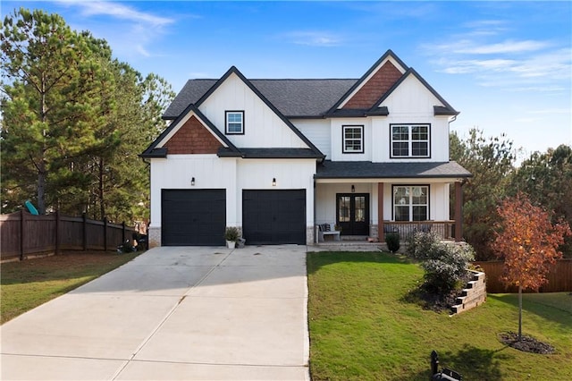 modern inspired farmhouse with french doors, a porch, a front yard, and a garage