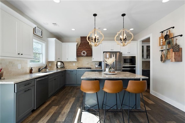 kitchen featuring gray cabinets, white cabinets, appliances with stainless steel finishes, and dark wood-type flooring