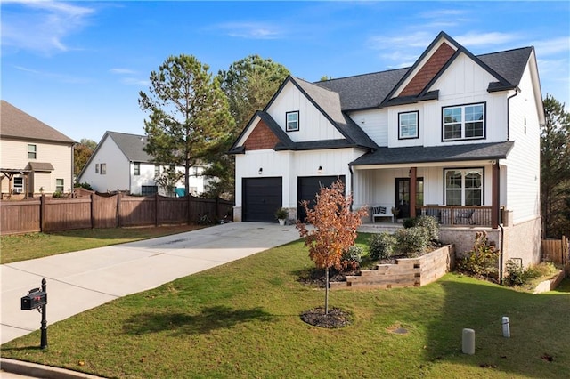 view of front of house featuring a front yard, a porch, and a garage