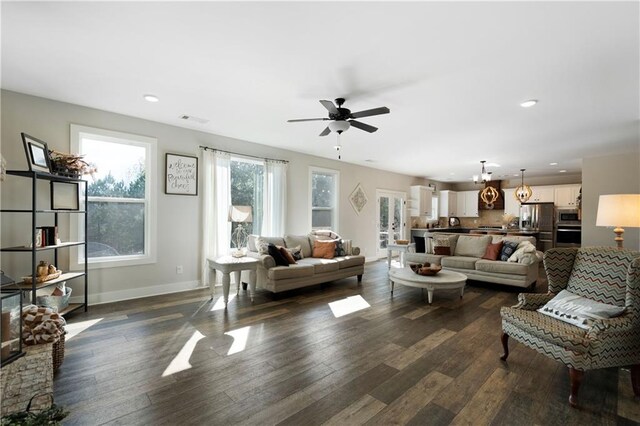 living room featuring dark hardwood / wood-style floors and ceiling fan