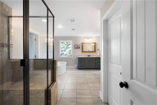 bathroom with tile patterned flooring, vanity, and independent shower and bath