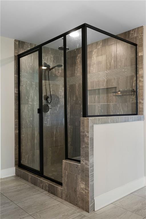 bathroom with a shower with door