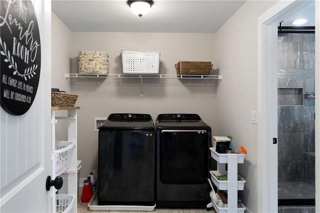 clothes washing area featuring washing machine and clothes dryer