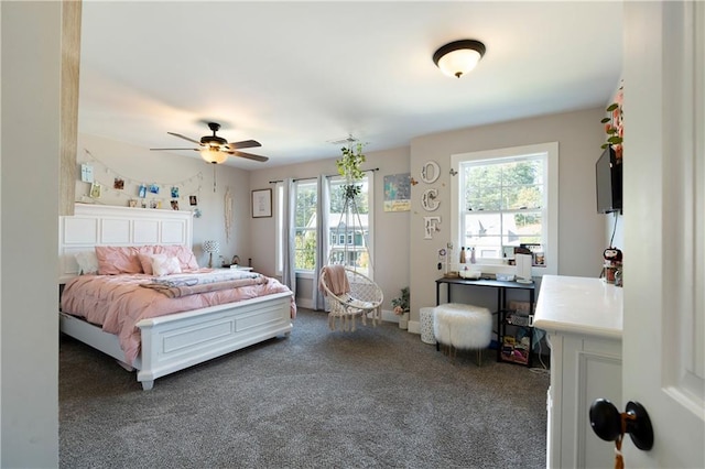 bedroom with ceiling fan and dark colored carpet