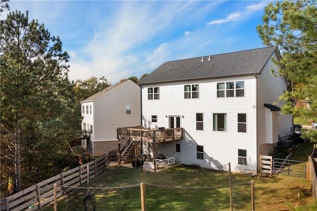 back of house with a yard and a deck