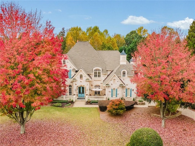 rear view of property featuring a yard