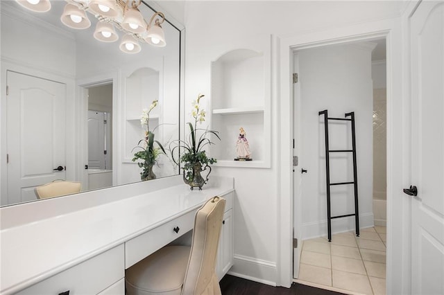 bathroom with vanity, ornamental molding, and tile patterned floors