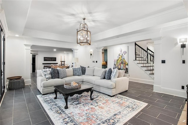 living room with crown molding, ornate columns, and a chandelier