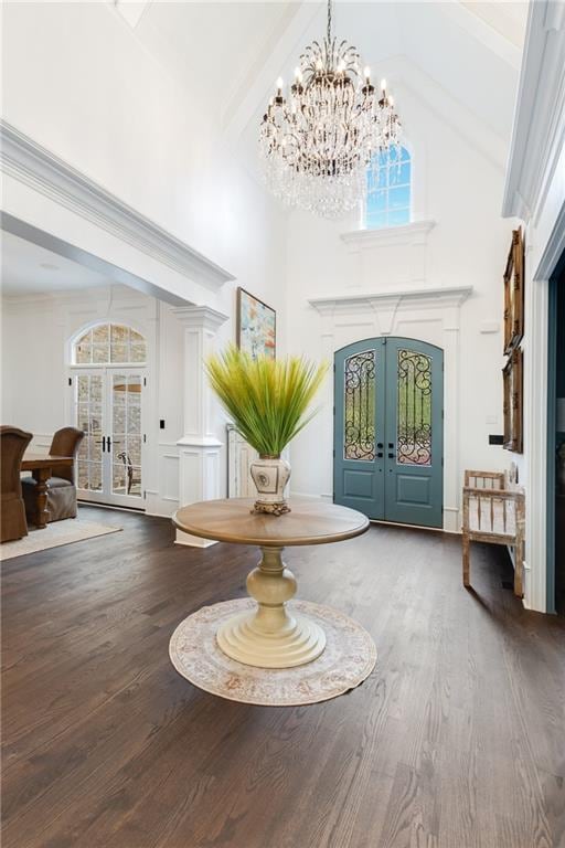 entryway with french doors, hardwood / wood-style floors, beam ceiling, and plenty of natural light