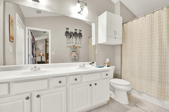 bathroom featuring tile patterned flooring, vanity, and toilet