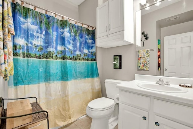 bathroom with tile patterned flooring, vanity, and toilet