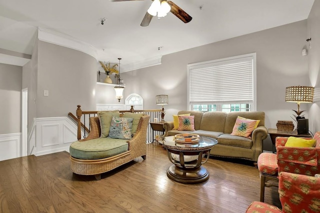 living room featuring crown molding, hardwood / wood-style flooring, and ceiling fan