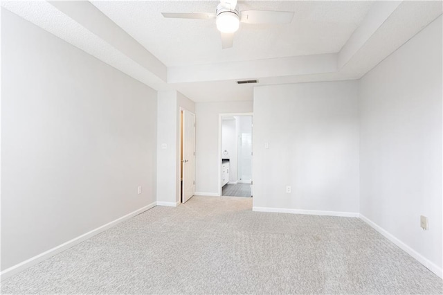 unfurnished bedroom with carpet floors, a ceiling fan, visible vents, and baseboards