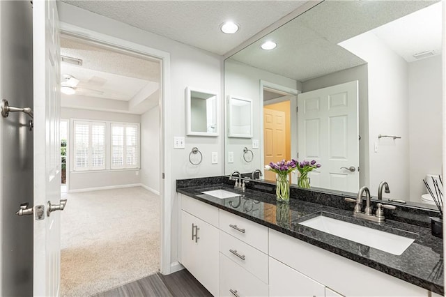 full bathroom with ceiling fan, a sink, baseboards, and double vanity