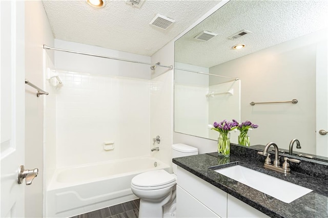 bathroom featuring bathtub / shower combination, visible vents, toilet, vanity, and a textured ceiling