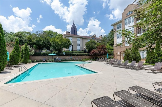 pool featuring a patio area and fence