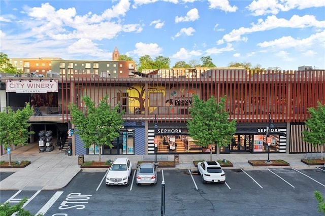 view of building exterior featuring uncovered parking