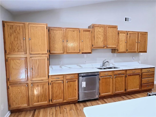 kitchen with stainless steel dishwasher, lofted ceiling, sink, and light wood-type flooring