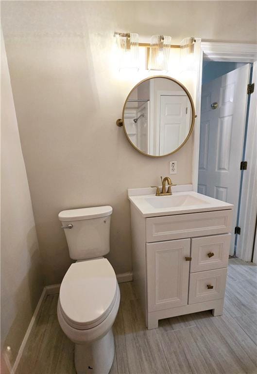 bathroom featuring vanity, toilet, and wood-type flooring