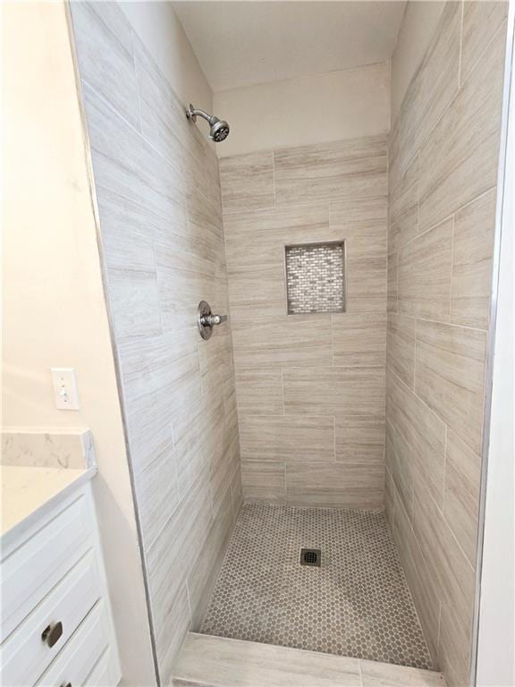 bathroom featuring vanity and a tile shower