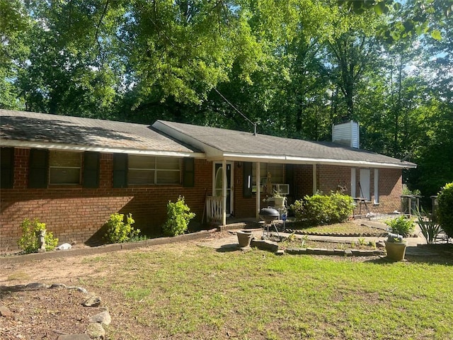 10199 Starr St SW, Covington, GA 30014 - ranch-style house featuring a front yard, a chimney, brick siding, and covered porch