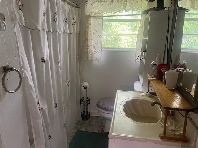 10199 Starr St SW, Covington, GA 30014 - bathroom featuring toilet, vanity, curtained shower, and tile patterned floors