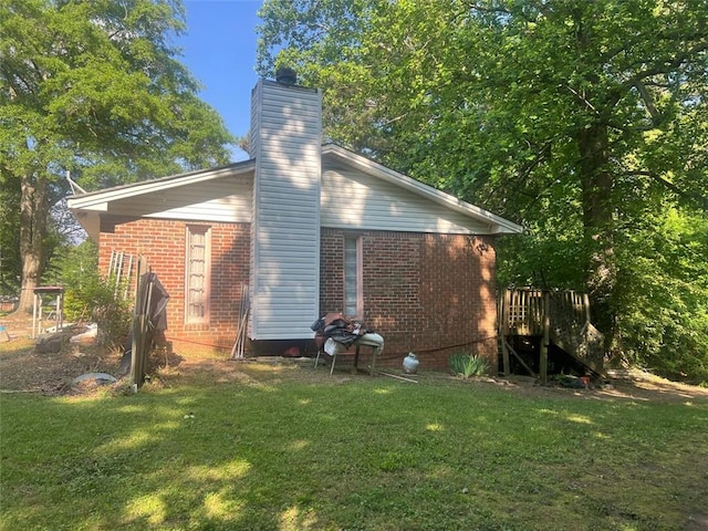 10199 Starr St SW, Covington, GA 30014 - view of home's exterior with brick siding, a lawn, and a chimney