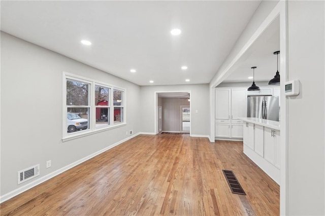 unfurnished living room with light hardwood / wood-style flooring