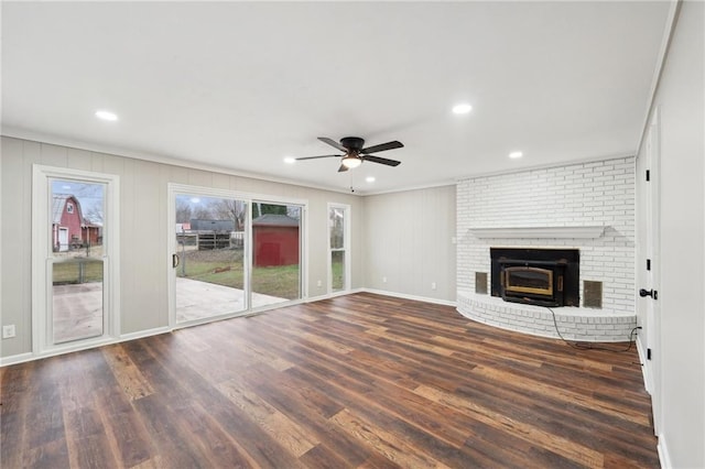 unfurnished living room featuring ceiling fan, dark wood-type flooring, and ornamental molding