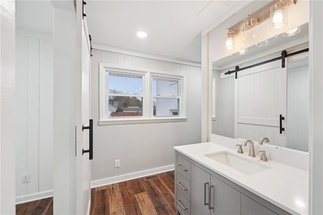 bathroom featuring hardwood / wood-style floors, vanity, and ornamental molding