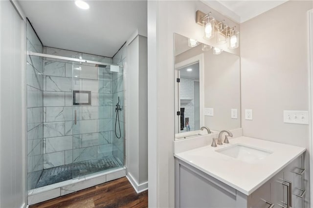 bathroom with vanity, wood-type flooring, and a shower with shower door