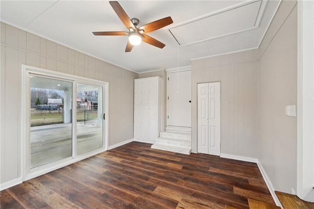 empty room with dark hardwood / wood-style floors and ceiling fan